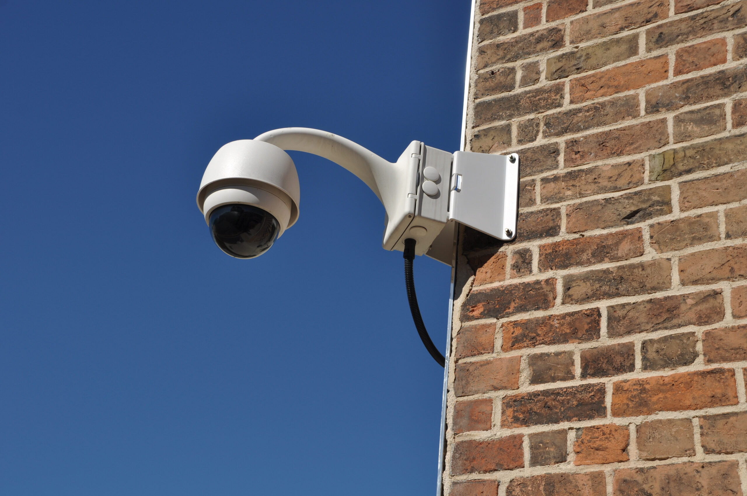 surveillance camera on brick corner